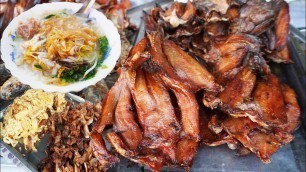 'Street food breakfast, eating pork rice porridge and fried noodles, Cambodian street food'