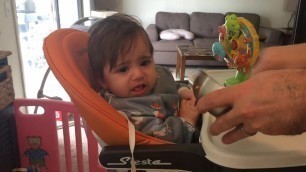 '10 months old baby girl eating food'