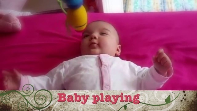 '4 months old baby playing'