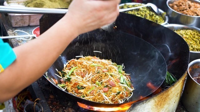 'Chinese Street Food  fried rice with eggs, fried noodles, colorful fruit yogurt  at night market'