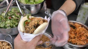 'London Street Food. Tasty Chinese-Style Pork Bun Eaten in Camden Town'