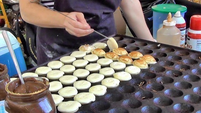 'London Street Food. Cooking Sweet Dutch Pancakes \"poffertjes\" in Camden Lock Market'